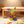 Colorful magnetic building blocks on a carpeted floor with a wooden table in the background.